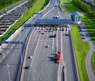 Aerial view of modern highway interchange near city on a sunny summer day.