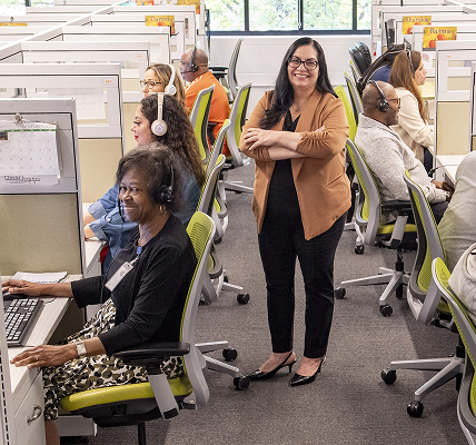 - Lighthouse Enterprises Diverse call center agents at cubicles with headsets; a smiling supervisor stands in the middle.
