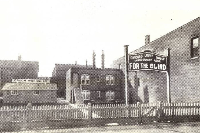 Archival photograph of the Chicago Light House Improvement Association for the Blind, with its broom workshop, in the early 1900s.